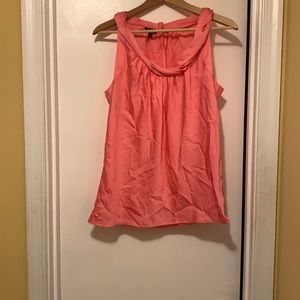Coral sleeveless blouse.